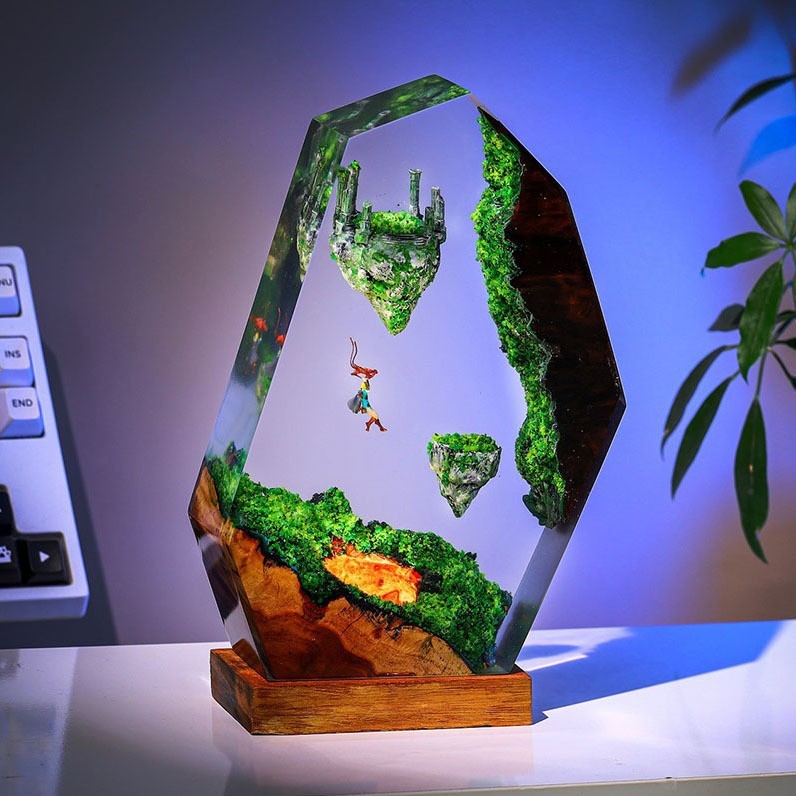 Sky Isles Resin Lamp on a desk, floating islands with ruins sealed in clear resin on a wood base
