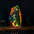 The Grey Wizard Resin Lamp lit on a wood base