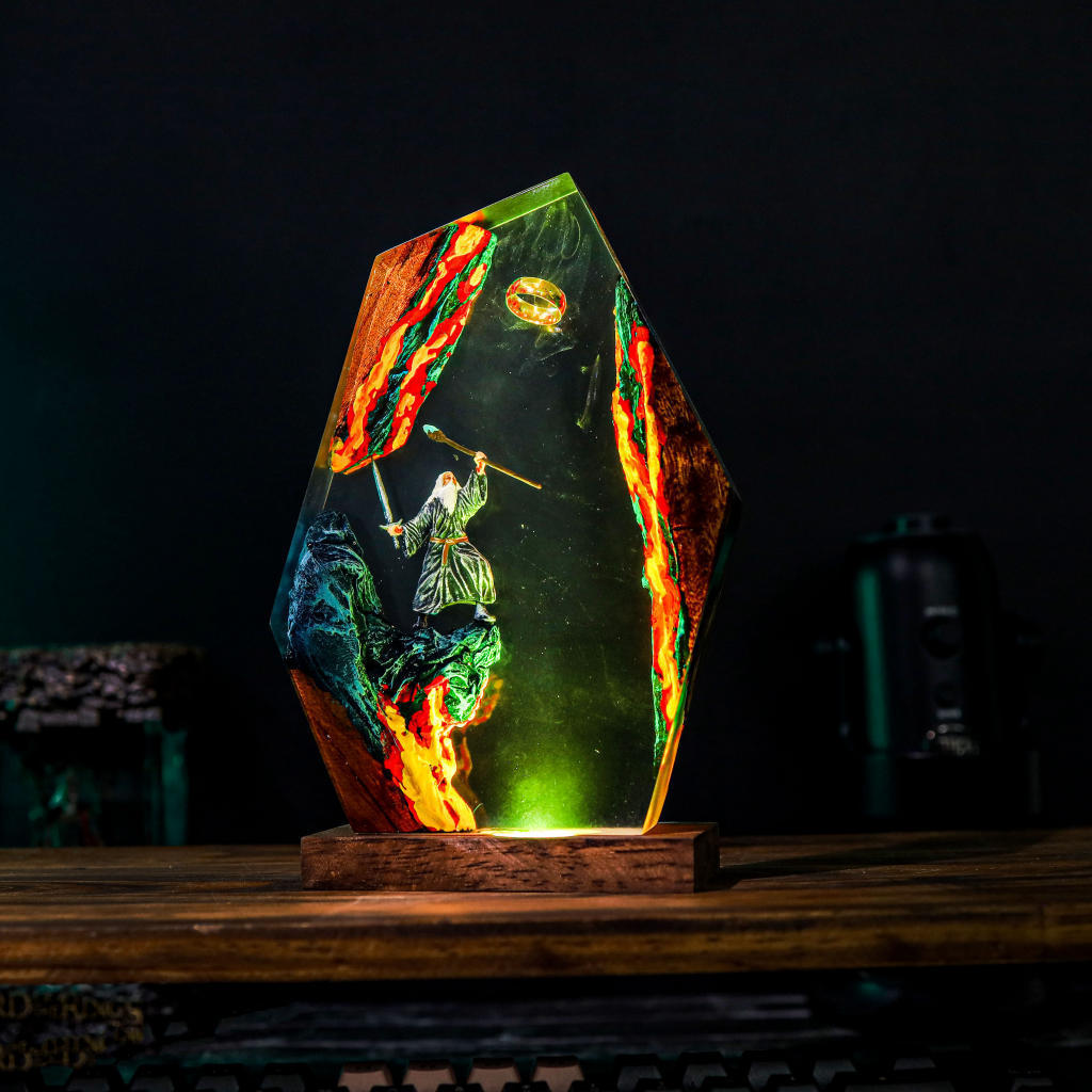 The Grey Wizard Resin Lamp lit on a wood base