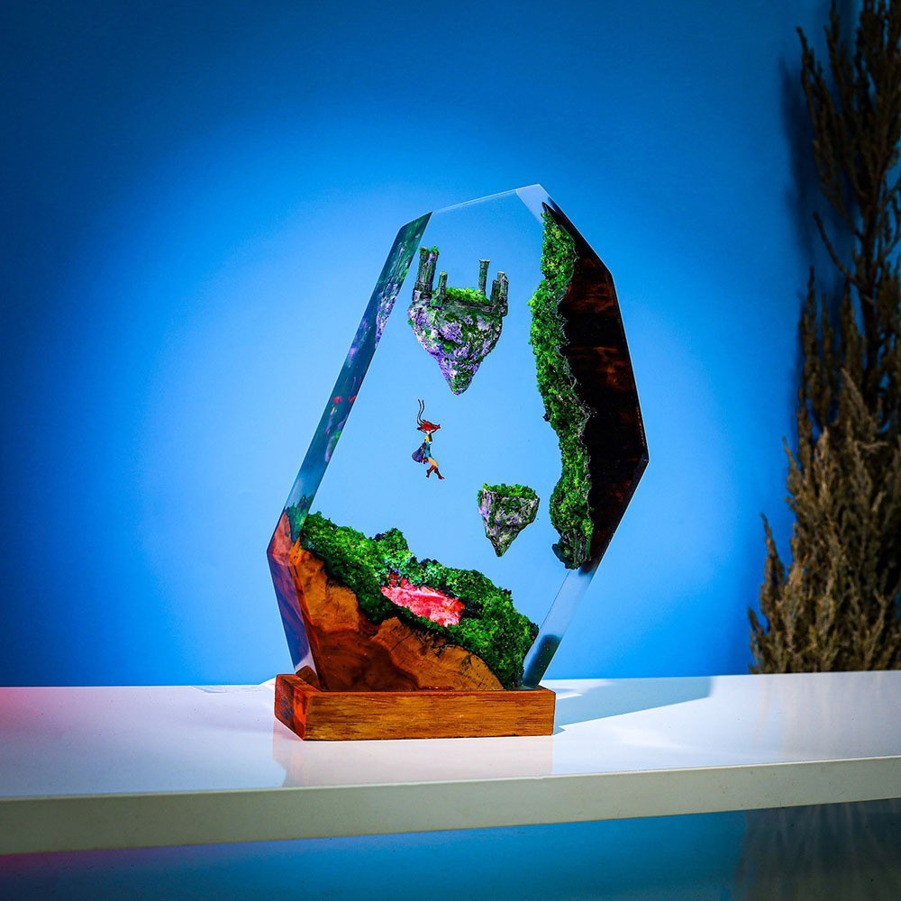 Sky Isles Resin Lamp lit against a blue background, glider figure falling between two floating islands