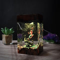 Web and Symbiote Resin Lamp lit on a wood base