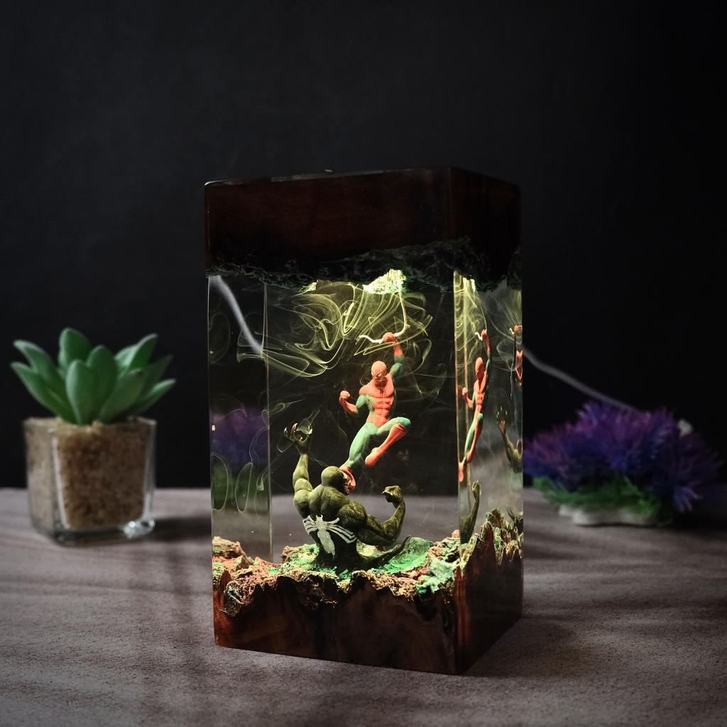 Web and Symbiote Resin Lamp lit on a wood base