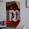 Heroes Tower Resin Lamp lit on a wood base