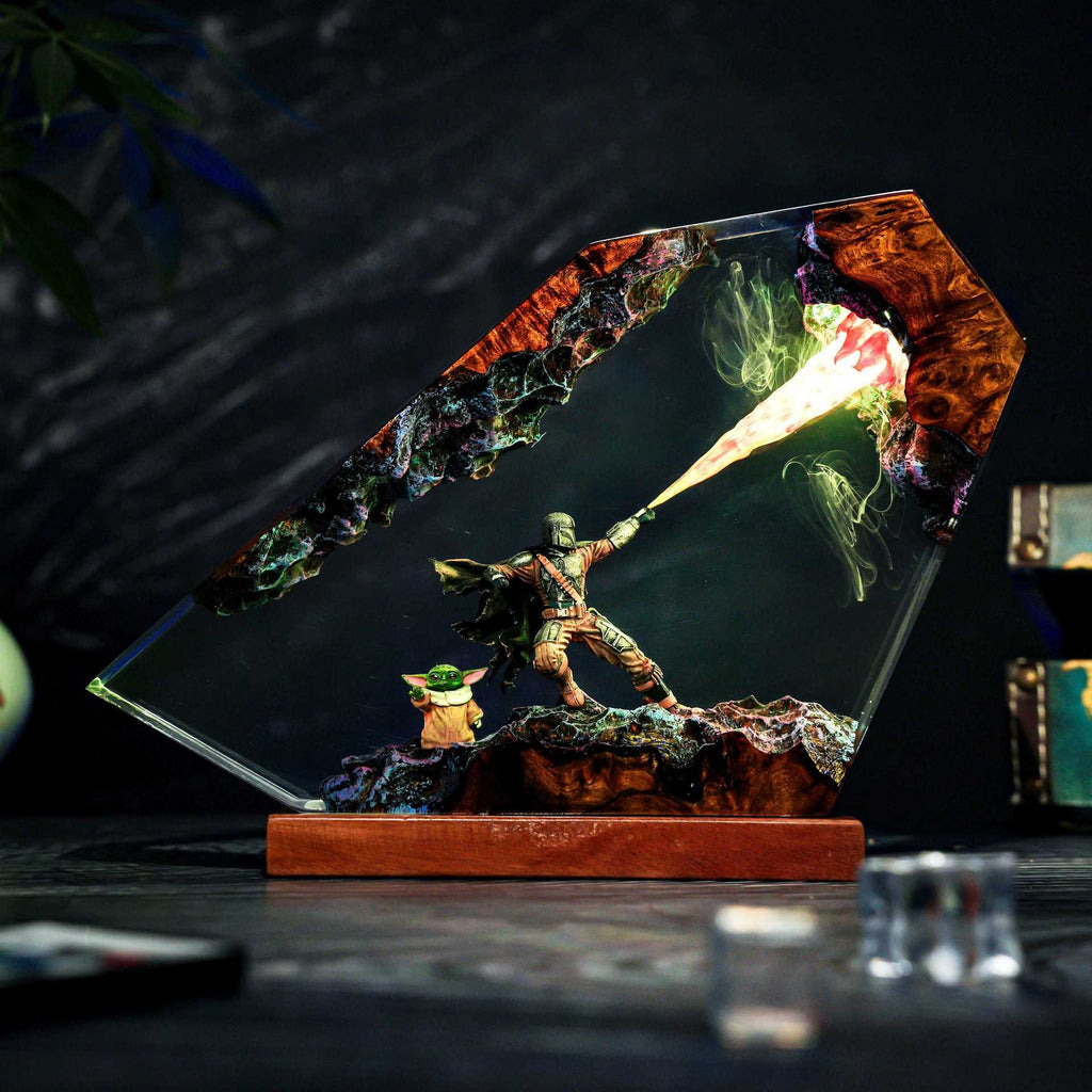 The Bounty Hunter Resin Lamp lit on a wood base