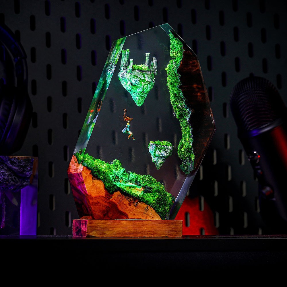 Angled view of the Sky Isles Resin Lamp showing the mossy cliff edge and molten orange vein in the rock